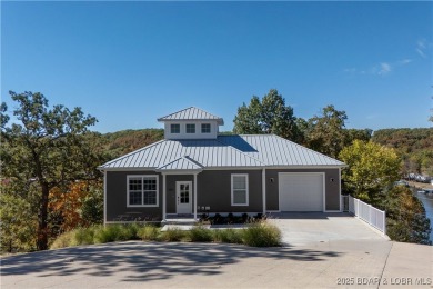 This beautiful 4-bedroom home offers great water views from one on The Oaks Golf Course in Missouri - for sale on GolfHomes.com, golf home, golf lot