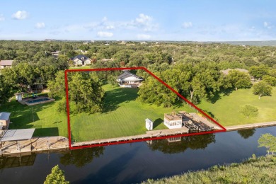 VIBRANT INKS LAKE COTTAGE -- Set on 1.2+ acres across two on Highland Lakes Golf Club in Texas - for sale on GolfHomes.com, golf home, golf lot
