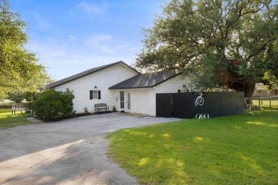 VIBRANT INKS LAKE COTTAGE -- Set on 1.2+ acres across two on Highland Lakes Golf Club in Texas - for sale on GolfHomes.com, golf home, golf lot