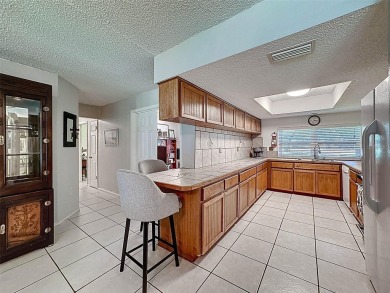 Nestled alongside the tranquil 14th hole of the golf course on Beacon Woods Golf Club in Florida - for sale on GolfHomes.com, golf home, golf lot