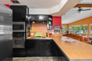 VIBRANT INKS LAKE COTTAGE -- Set on 1.2+ acres across two on Highland Lakes Golf Club in Texas - for sale on GolfHomes.com, golf home, golf lot