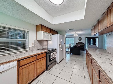 Nestled alongside the tranquil 14th hole of the golf course on Beacon Woods Golf Club in Florida - for sale on GolfHomes.com, golf home, golf lot