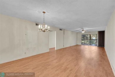 Deluxe Spacious Corner, Screened  Enclosed Balcony with Lake on Wynmoor Golf Course in Florida - for sale on GolfHomes.com, golf home, golf lot