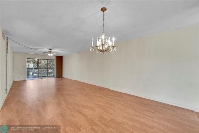 Deluxe Spacious Corner, Screened  Enclosed Balcony with Lake on Wynmoor Golf Course in Florida - for sale on GolfHomes.com, golf home, golf lot