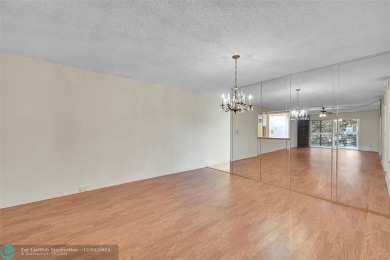 Deluxe Spacious Corner, Screened  Enclosed Balcony with Lake on Wynmoor Golf Course in Florida - for sale on GolfHomes.com, golf home, golf lot