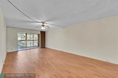 Deluxe Spacious Corner, Screened  Enclosed Balcony with Lake on Wynmoor Golf Course in Florida - for sale on GolfHomes.com, golf home, golf lot