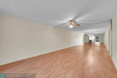 Deluxe Spacious Corner, Screened  Enclosed Balcony with Lake on Wynmoor Golf Course in Florida - for sale on GolfHomes.com, golf home, golf lot
