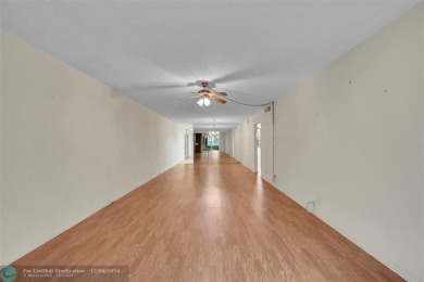 Deluxe Spacious Corner, Screened  Enclosed Balcony with Lake on Wynmoor Golf Course in Florida - for sale on GolfHomes.com, golf home, golf lot