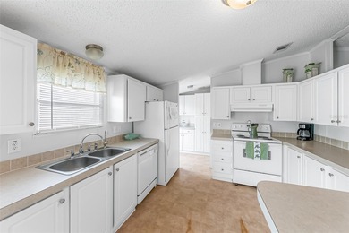 Enjoy easy coastal living in this fully furnished 3-bedroom on Barefoot Bay Golf Course in Florida - for sale on GolfHomes.com, golf home, golf lot