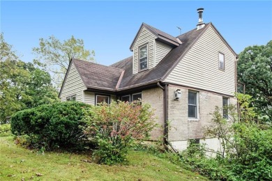 This private and secluded two story home sits on a huge, treed on Loch Lloyd Country Club in Missouri - for sale on GolfHomes.com, golf home, golf lot
