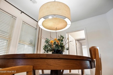 Welcome to this exceptional end-unit first-floor condominium on Carolina National Golf Club in North Carolina - for sale on GolfHomes.com, golf home, golf lot