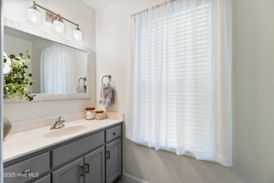 Welcome to this exceptional end-unit first-floor condominium on Carolina National Golf Club in North Carolina - for sale on GolfHomes.com, golf home, golf lot