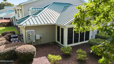 Welcome to this exceptional end-unit first-floor condominium on Carolina National Golf Club in North Carolina - for sale on GolfHomes.com, golf home, golf lot
