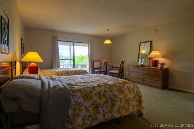 Welcome to your dream retreat in Tan Tar A Estates, an exclusive on The Oaks Golf Course in Missouri - for sale on GolfHomes.com, golf home, golf lot