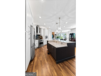 Experience panoramic views of the lake and golf course in this on Summergrove Golf Club in Georgia - for sale on GolfHomes.com, golf home, golf lot