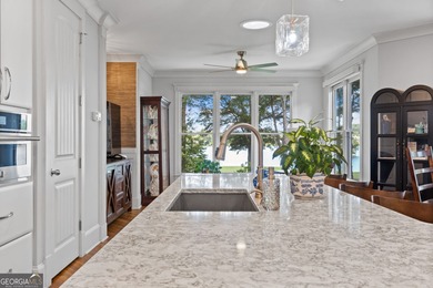 Experience panoramic views of the lake and golf course in this on Summergrove Golf Club in Georgia - for sale on GolfHomes.com, golf home, golf lot