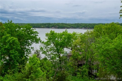 Welcome to your dream retreat in Tan Tar A Estates, an exclusive on The Oaks Golf Course in Missouri - for sale on GolfHomes.com, golf home, golf lot
