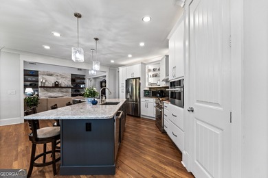 Experience panoramic views of the lake and golf course in this on Summergrove Golf Club in Georgia - for sale on GolfHomes.com, golf home, golf lot