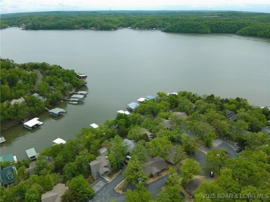Welcome to your dream retreat in Tan Tar A Estates, an exclusive on The Oaks Golf Course in Missouri - for sale on GolfHomes.com, golf home, golf lot