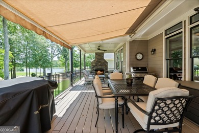 Experience panoramic views of the lake and golf course in this on Summergrove Golf Club in Georgia - for sale on GolfHomes.com, golf home, golf lot