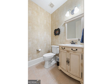 Experience panoramic views of the lake and golf course in this on Summergrove Golf Club in Georgia - for sale on GolfHomes.com, golf home, golf lot