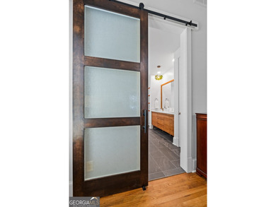 Experience panoramic views of the lake and golf course in this on Summergrove Golf Club in Georgia - for sale on GolfHomes.com, golf home, golf lot