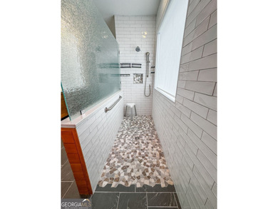 Experience panoramic views of the lake and golf course in this on Summergrove Golf Club in Georgia - for sale on GolfHomes.com, golf home, golf lot