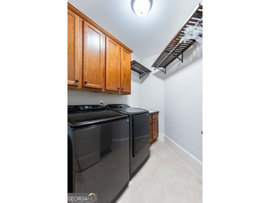 Experience panoramic views of the lake and golf course in this on Summergrove Golf Club in Georgia - for sale on GolfHomes.com, golf home, golf lot