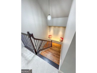 Experience panoramic views of the lake and golf course in this on Summergrove Golf Club in Georgia - for sale on GolfHomes.com, golf home, golf lot