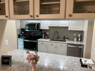 VILLA with TRANQUIL GOLF COURSE VIEWS IN EAST LAKE WOODLANDS on East Lake Woodlands Country Club in Florida - for sale on GolfHomes.com, golf home, golf lot