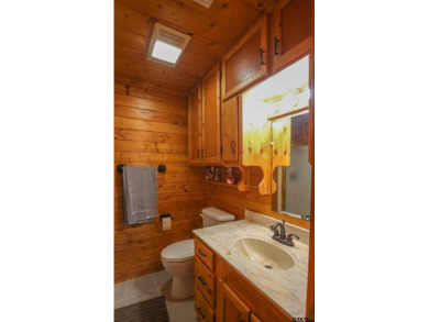 Nestled in the heart of the highly sought-after Holly Lake Ranch on Holly Lake Ranch Golf Club in Texas - for sale on GolfHomes.com, golf home, golf lot
