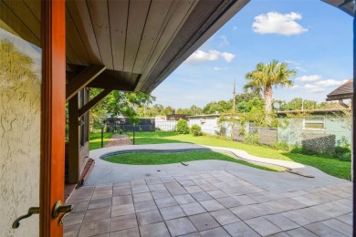 This lovely home in Forest Hills comes with its own fish, flower on Babe Zaharias Golf Course in Florida - for sale on GolfHomes.com, golf home, golf lot