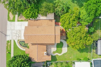 This lovely home in Forest Hills comes with its own fish, flower on Babe Zaharias Golf Course in Florida - for sale on GolfHomes.com, golf home, golf lot