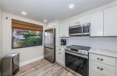 Tastefully remodeled in 2022 with high-end finishes, this ground on Isla Del Sol Yacht and Country Club in Florida - for sale on GolfHomes.com, golf home, golf lot