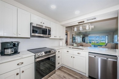 Tastefully remodeled in 2022 with high-end finishes, this ground on Isla Del Sol Yacht and Country Club in Florida - for sale on GolfHomes.com, golf home, golf lot