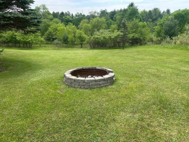 Nestled on two spacious lots totaling 0.79 acres with just one on Sugar Springs Country Club in Michigan - for sale on GolfHomes.com, golf home, golf lot