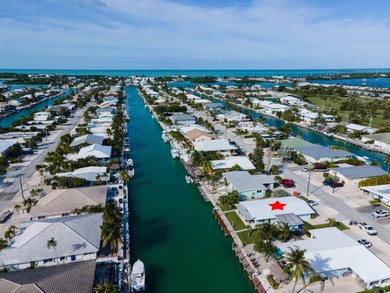 If you need more dockage than most half duplexes in Key Colony on Key Colony Beach Golf Course in Florida - for sale on GolfHomes.com, golf home, golf lot