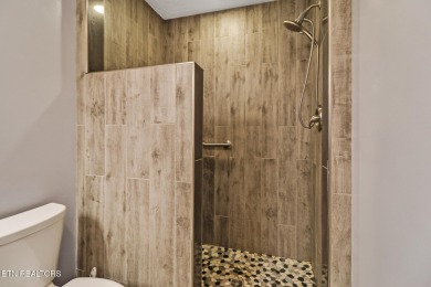 Lake-view living on a wooded acre-this 1,800 SF, single-level on Lake Tansi Village Country Club in Tennessee - for sale on GolfHomes.com, golf home, golf lot