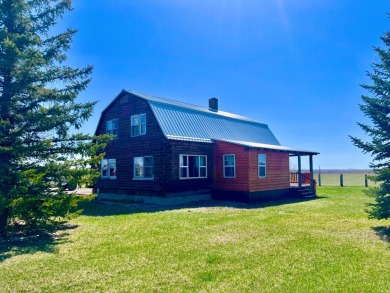 A log-style residence sits on the peaceful plains of central on Choteau Country Club in Montana - for sale on GolfHomes.com, golf home, golf lot