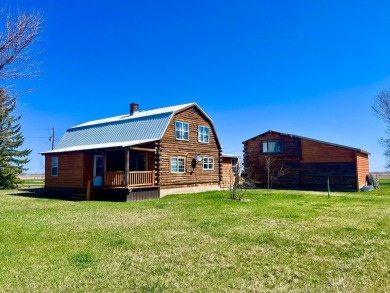 A log-style residence sits on the peaceful plains of central on Choteau Country Club in Montana - for sale on GolfHomes.com, golf home, golf lot