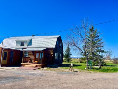 A log-style residence sits on the peaceful plains of central on Choteau Country Club in Montana - for sale on GolfHomes.com, golf home, golf lot