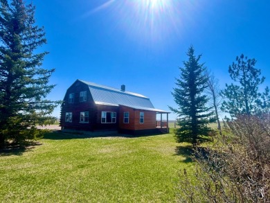 A log-style residence sits on the peaceful plains of central on Choteau Country Club in Montana - for sale on GolfHomes.com, golf home, golf lot