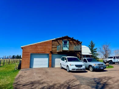 A log-style residence sits on the peaceful plains of central on Choteau Country Club in Montana - for sale on GolfHomes.com, golf home, golf lot