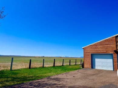 A log-style residence sits on the peaceful plains of central on Choteau Country Club in Montana - for sale on GolfHomes.com, golf home, golf lot