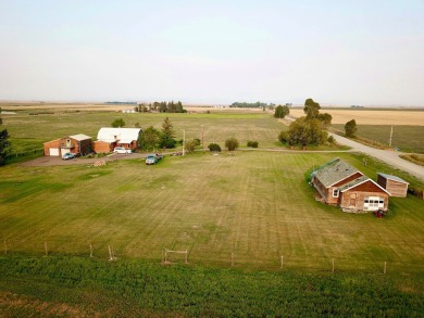 A log-style residence sits on the peaceful plains of central on Choteau Country Club in Montana - for sale on GolfHomes.com, golf home, golf lot