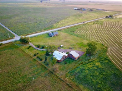 A log-style residence sits on the peaceful plains of central on Choteau Country Club in Montana - for sale on GolfHomes.com, golf home, golf lot