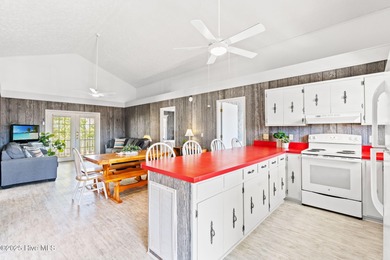 Charming Beach Cottage on Canal Lot with Boat Dock This is a on Sea Trail Golf Resort in North Carolina - for sale on GolfHomes.com, golf home, golf lot