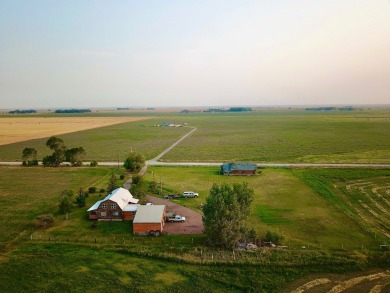 A log-style residence sits on the peaceful plains of central on Choteau Country Club in Montana - for sale on GolfHomes.com, golf home, golf lot