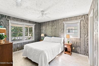 Charming Beach Cottage on Canal Lot with Boat Dock This is a on Sea Trail Golf Resort in North Carolina - for sale on GolfHomes.com, golf home, golf lot