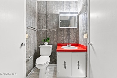 Charming Beach Cottage on Canal Lot with Boat Dock This is a on Sea Trail Golf Resort in North Carolina - for sale on GolfHomes.com, golf home, golf lot